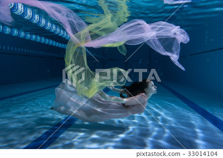 Swimmer underwater playing with cloth. Swimmer underwater playing with cloth. 33014104