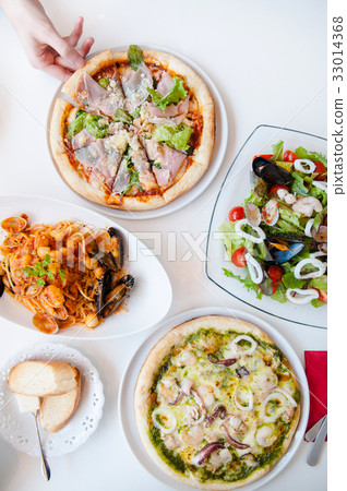 Italian pizza, pasta and salad on white table 33014368