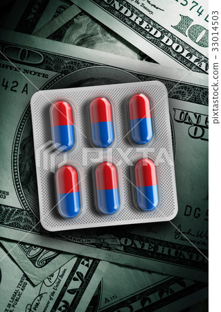 Red and blue pills in a blister on dollar bill Red and blue pills in a blister on dollar bill 33014503