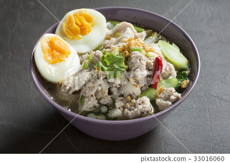 Spicy Tom Yam Wide Rice noodles soup with Vegetables and meats. Spicy Tom Yam Wide Rice noodles soup with Vegetables and meats. 33016060
