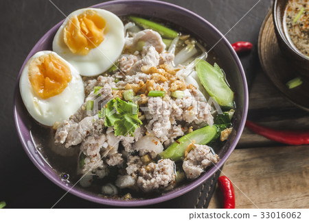 Spicy Tom Yam Wide Rice noodles soup with Vegetables and meats. Spicy Tom Yam Wide Rice noodles soup with Vegetables and meats. 33016062