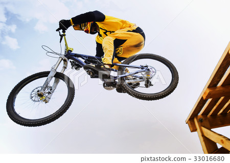 cyclist jump downhill cyclist jump downhill 33016680