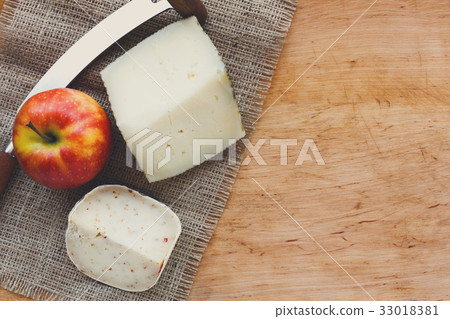 Cheese background. Gouda pesto pieces on wooden 33018381