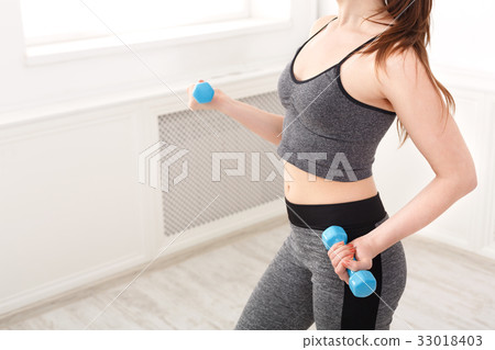Fitness model woman with dumbbells at studio Fitness model woman with dumbbells at studio 33018403
