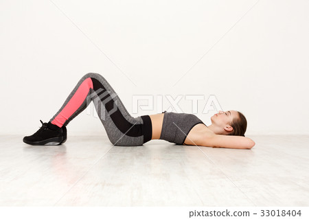 Fitness woman lay on floor at pilates training Fitness woman lay on floor at pilates training 33018404