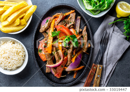 Peruvian dish Lomo saltado - beef tenderloin with Peruvian dish Lomo saltado - beef tenderloin with 33019447