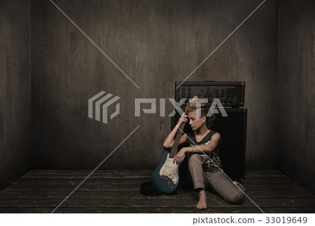 Female musician with a guitar 33019649