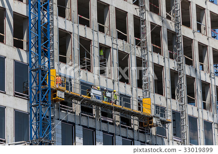 Workers on scaffolding Workers on scaffolding 33019899