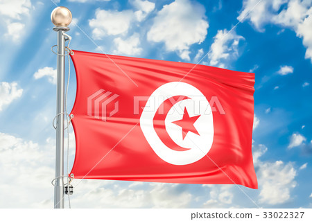 Tunisia flag waving in blue cloudy sky Tunisia flag waving in blue cloudy sky 33022327