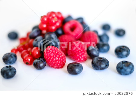 pile of mixed berries on white background 33022876