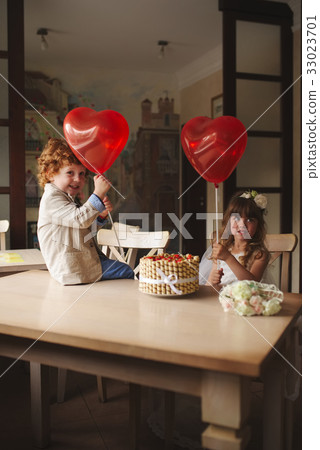 boy and girl having tea party in cafe boy and girl having tea party in cafe 33023701