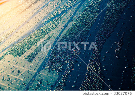 Water drops on glass with the sunlight. Water drops on glass with the sunlight. 33027076