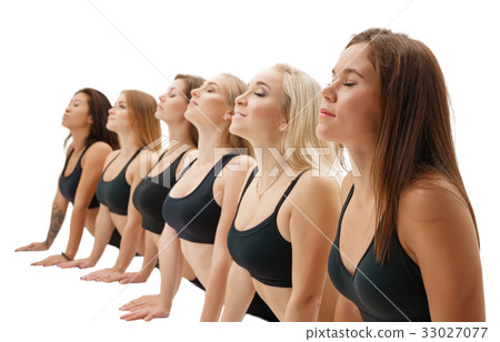 Slim sportswomen in tops exercising studio shot Slim sportswomen in tops exercising studio shot 33027077