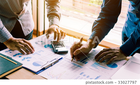 Two businessman team calculate with summary report Two businessman team calculate with summary report 33027797