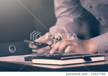 Businessman calculate about financial report Businessman calculate about financial report 33027798