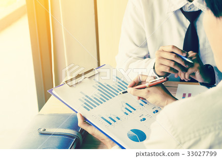 Businessman pointing the results on paperwork 33027799