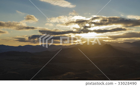 sun rays lits thru the clouds over the valley 33028490