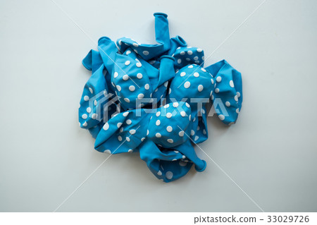 Deflated blue pastel white dots rubber balloon Deflated blue pastel white dots rubber balloon 33029726