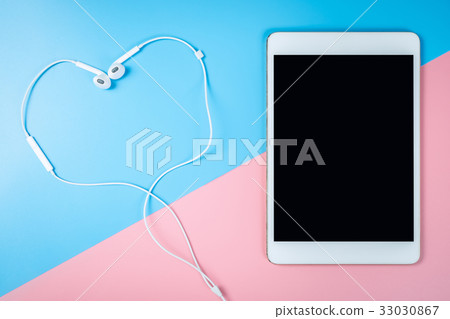 Tablet earphone on pastel background for Mock up Tablet earphone on pastel background for Mock up 33030867