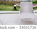 A row of empty pool chairs. 33031716