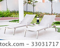 A row of empty pool chairs. 33031717