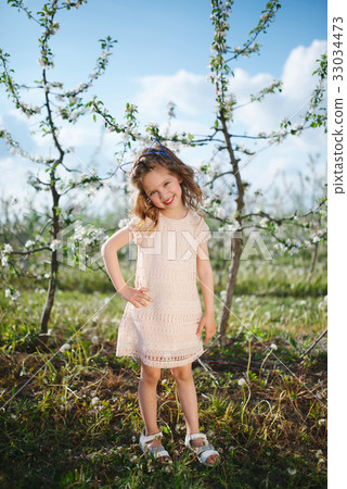 beautiful little girl in blooming garden 33034473