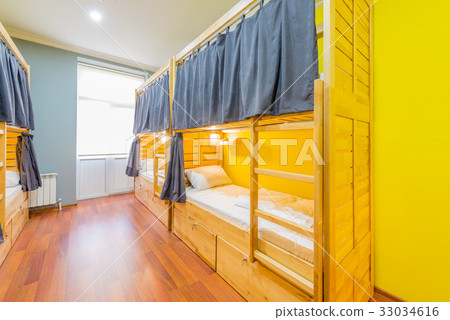Hostel dormitory beds arranged in room 33034616