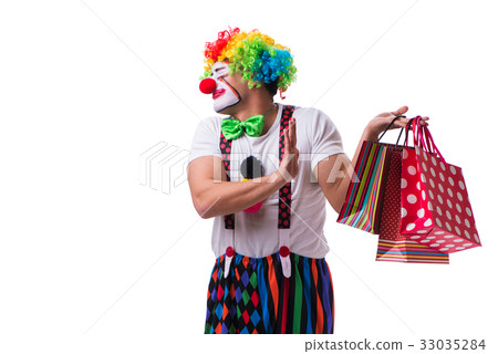 Funny clown after shopping bags isolated on white Funny clown after shopping bags isolated on white 33035284