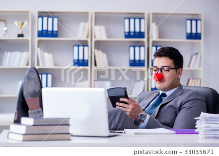 Clown businessman working in the office Clown businessman working in the office 33035671