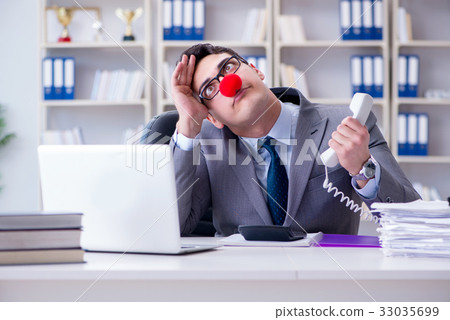 Clown businessman angry frustrated working in the Clown businessman angry frustrated working in the 33035699