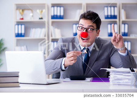 Clown businessman burning paper papers in the 33035704