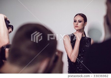 Photographers paparazzi take photos of woman in 33036982