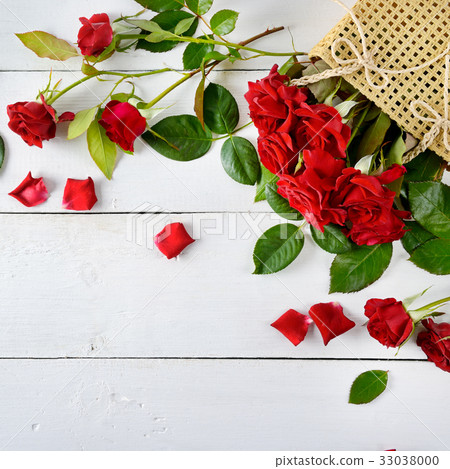 Red roses on a white wooden background. Red roses on a white wooden background. 33038000