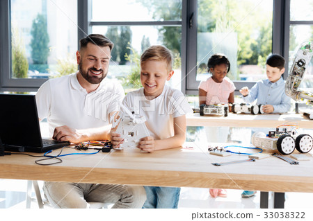 Teacher and student testing newly created robot Teacher and student testing newly created robot 33038322