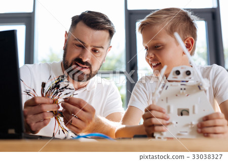 Pleasant teacher choosing a wire for the robot Pleasant teacher choosing a wire for the robot 33038327