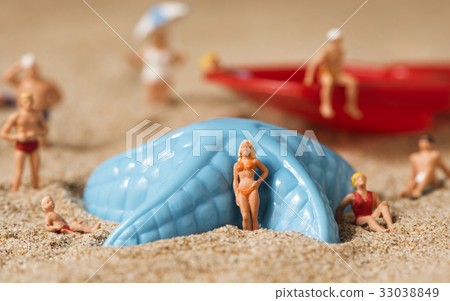 miniature people in swimsuit on the beach 33038849