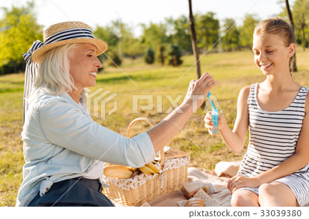 Cheerful woman going to blow soap bubbles Cheerful woman going to blow soap bubbles 33039380