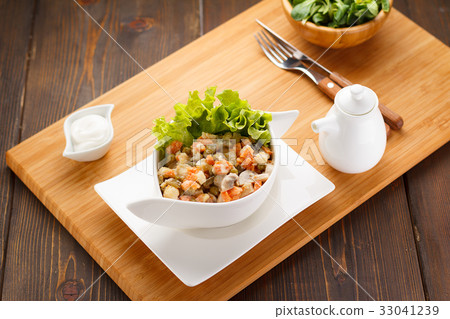 Russian salad Olivier on a white plate 33041239
