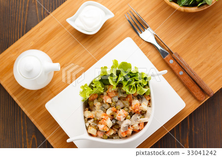 Russian salad Olivier on a white plate 33041242
