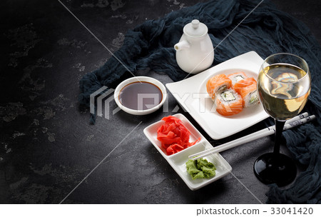 Sushi roll on a white plate, decorated  33041420