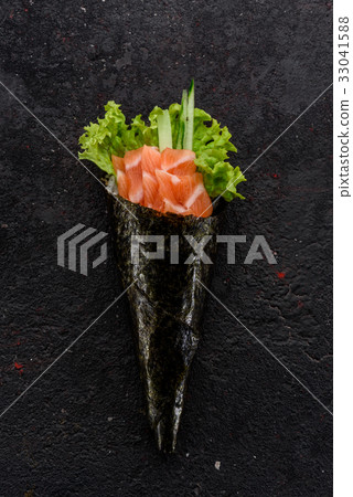 Salmon handmade sushi (temaki) on a stone plate. Salmon handmade sushi (temaki) on a stone plate. 33041588