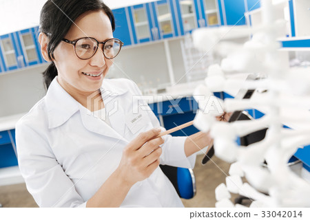 Intelligent female researcher studying genomics 33042014