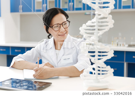 Delighted genetic researcher studying genome 33042016
