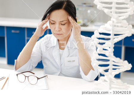 Unhappy tired woman suffering from the headache 33042019