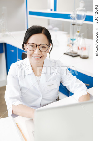 Joyful nice scientist using a laptop Joyful nice scientist using a laptop 33042063