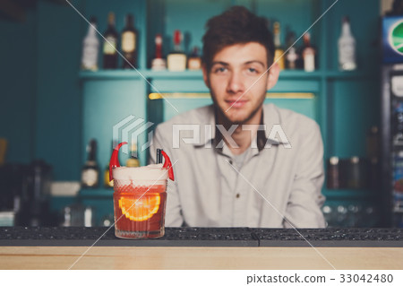 Bartender offers exotic spicy alcoholic cocktail 33042480