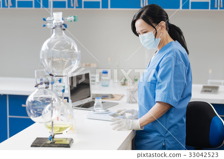 Smart professional scientist standing at the table 33042523