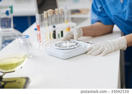 Close up of powder being weighted on electronic 33042539