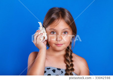 Happy child listen to seashell . Summer vacation Happy child listen to seashell . Summer vacation 33042598