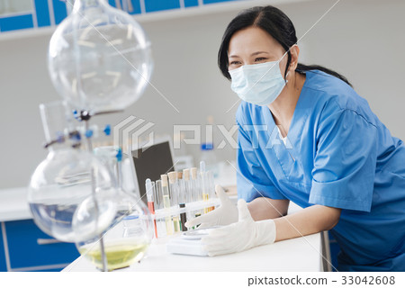 Happy cheerful scientist holding electronic scales 33042608